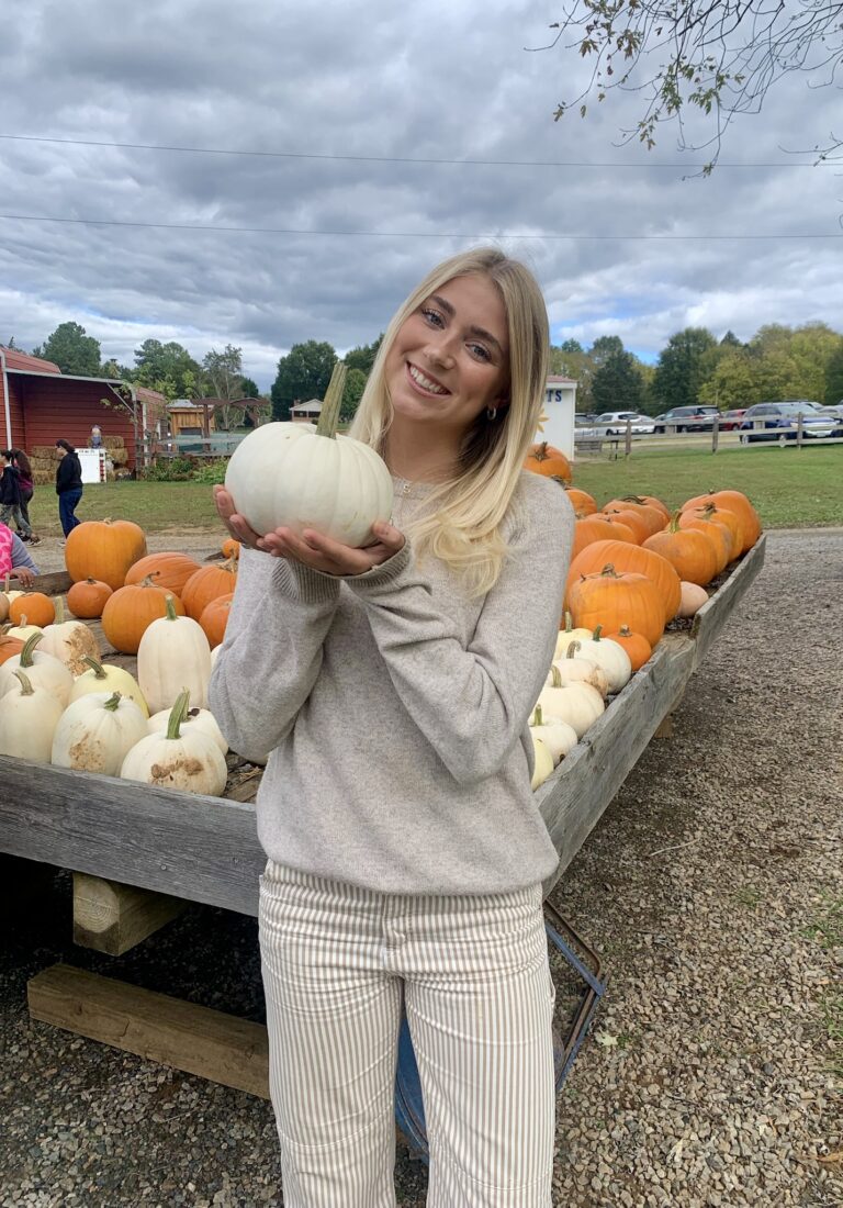 Student-athlete Olivia Appelberg holding a pumpkin