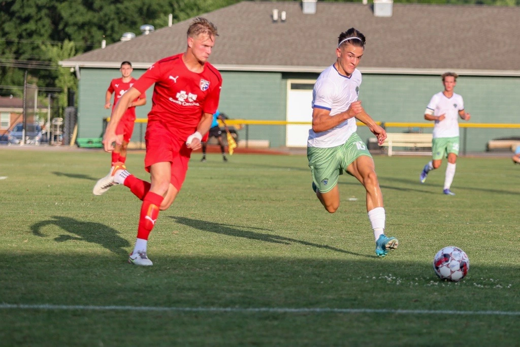 Male college soccer player on field