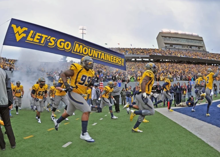 american football players running on field