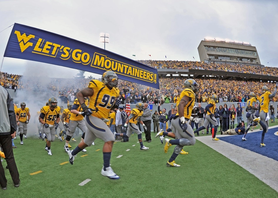 american football players running on field