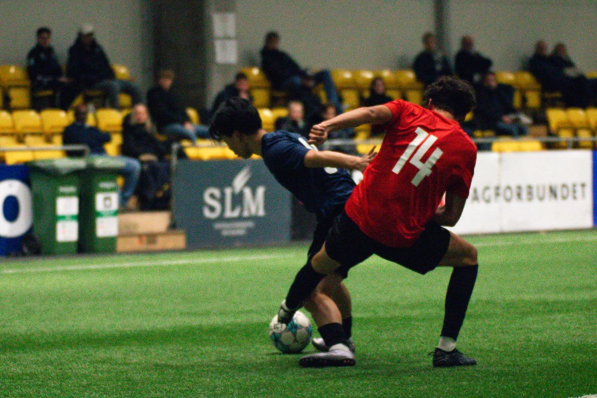 Två spelare som slåss om en boll medan collegetränare tittar på Keystone Sports College Soccer Showcase